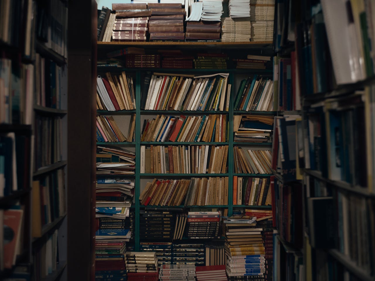 A view of overflowing bookshelves in an antique bookstore in Antalya, Turkey, showcasing a wide range of literature.